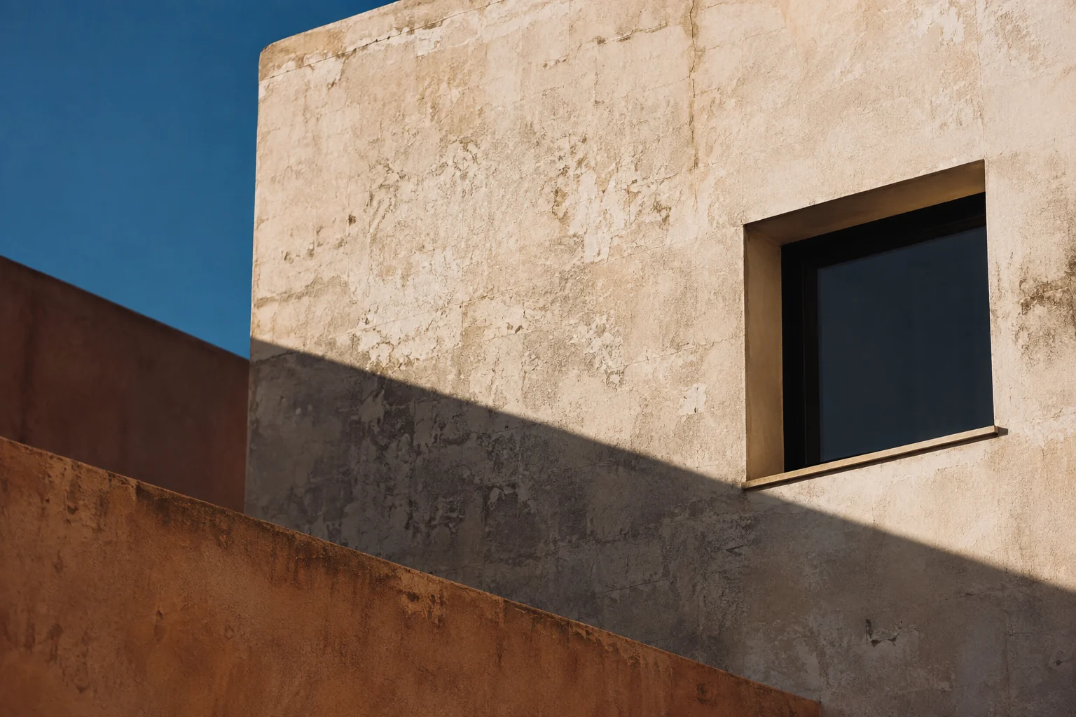 Generated visual placeholder: afternoon shadows across a pale concrete facade and a dark window.